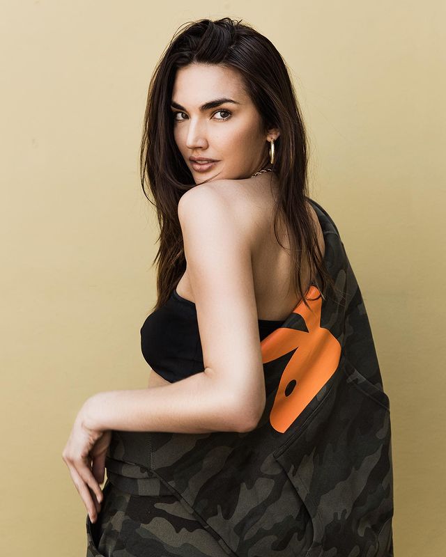 Hailee Keanna Lautenbach posing in a black sleeveless top and spotted grey jacket with an orange rabbit on it.